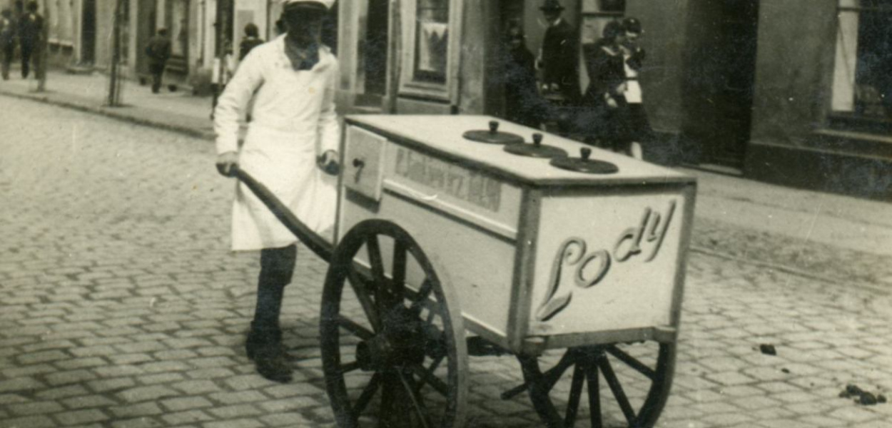 Foto (Archiwum): Uliczni sprzedawcy lodów w Brodnicy. Zdjęcia pochodzić mogą z przełomu lat 20. i 30. XX wieku. W tego typu wózkach znajdowały się dwie lub trzy komory z termosami do lodów. Oprócz luków na termosy i kilku szufladek ręczne wózki miały napis 'Lody', a także dane właściciela z numerem telefonu. Na zbliżeniu odczytać można: 'P. Jankiewicz [lub Jaśkiewicz]. Tel.90'.