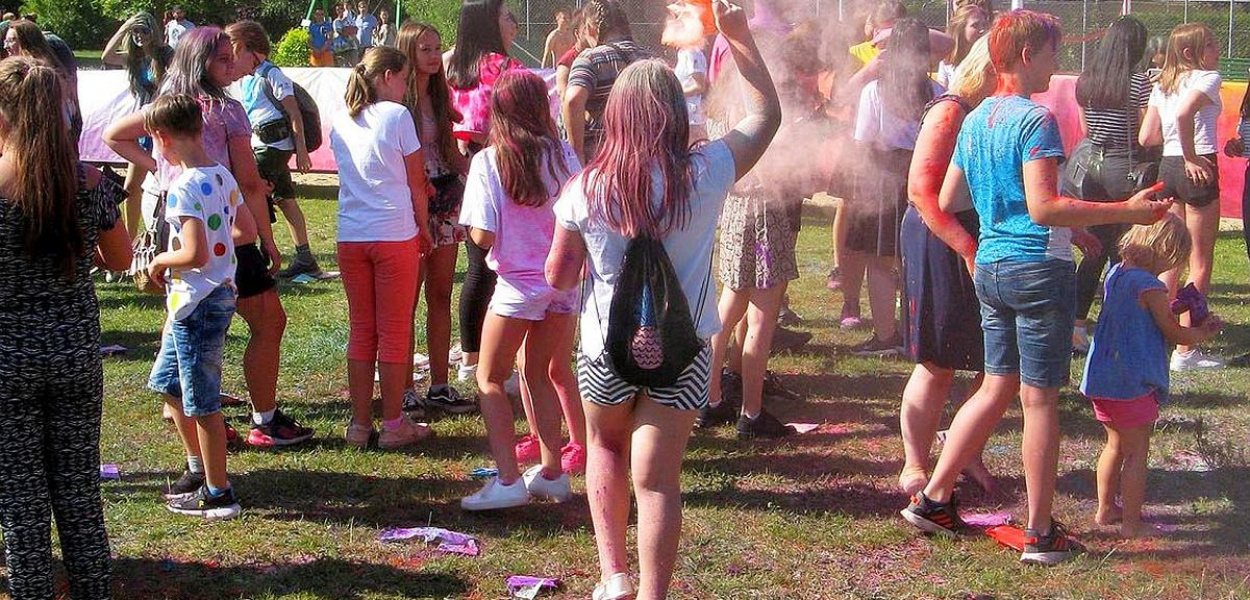 Foto: Bogdan Bolumiński: Młodzi ludzie obsypani proszkami Holi, bawili się przed sceną w rytm muzyki DJa.